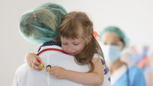 Child hugging pediatric surgeon